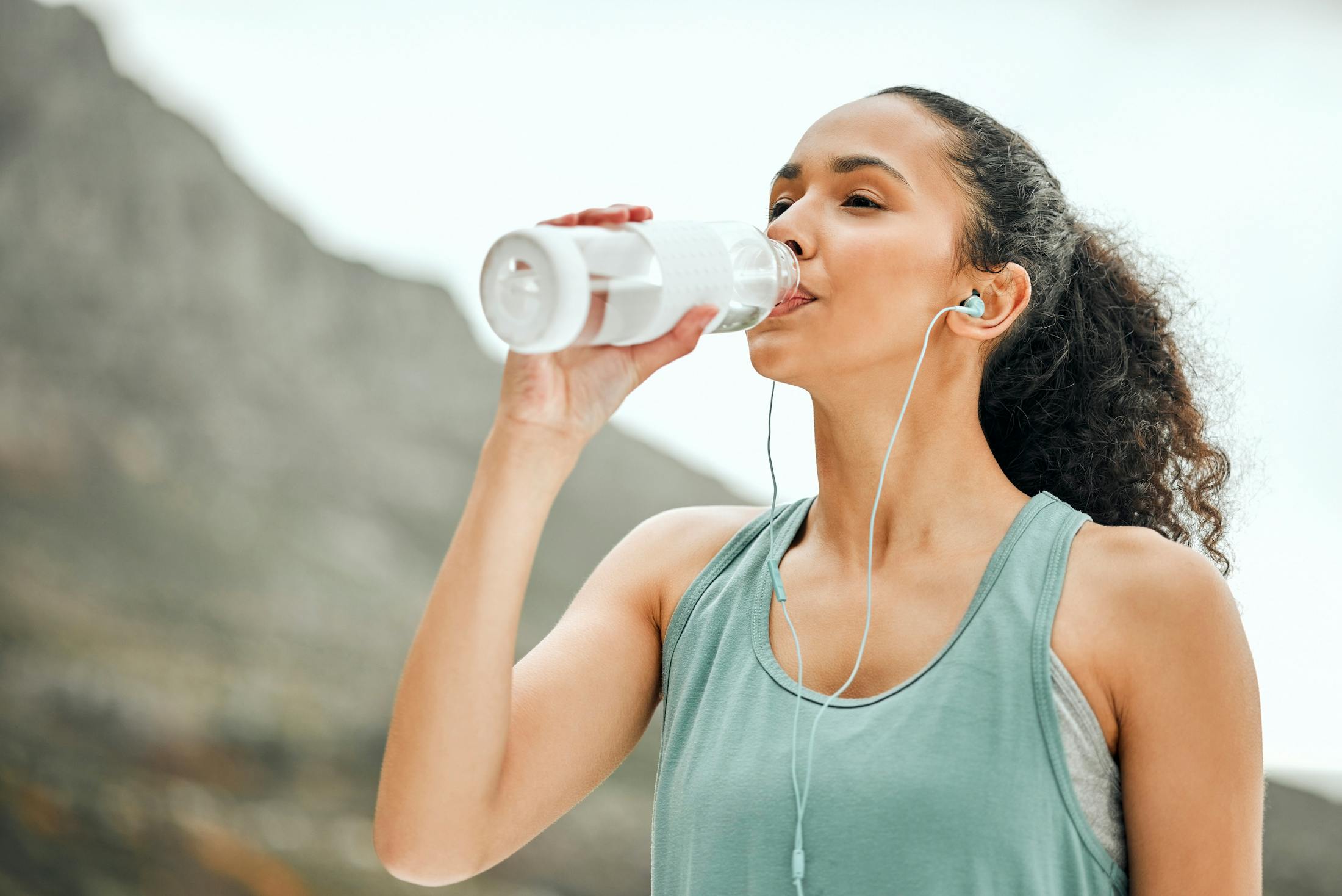 woman drinking water after Semaglutide in Irvine