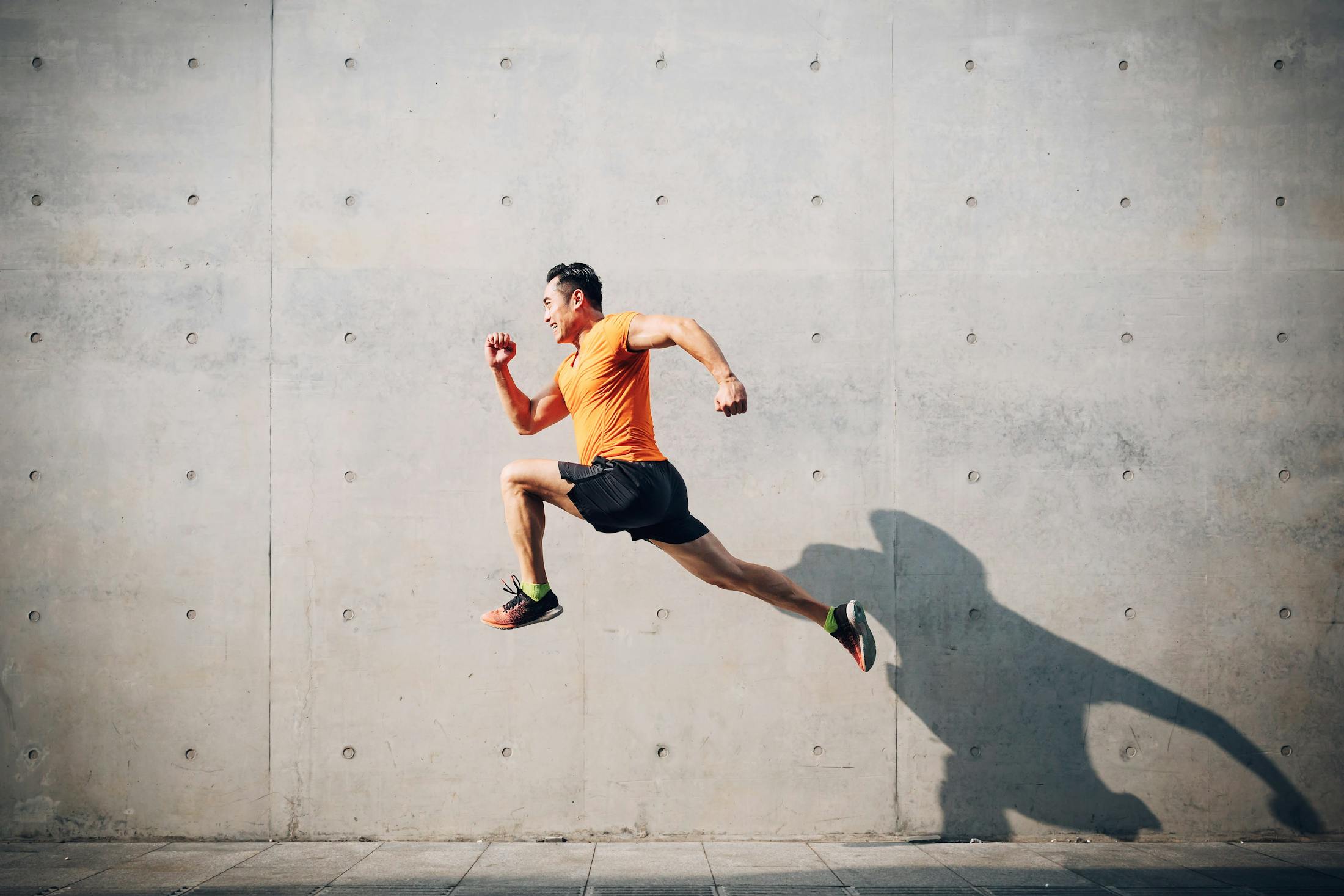 Man running and jumping after receiving vitamin injections from Genesis Lifestyle Medicine.