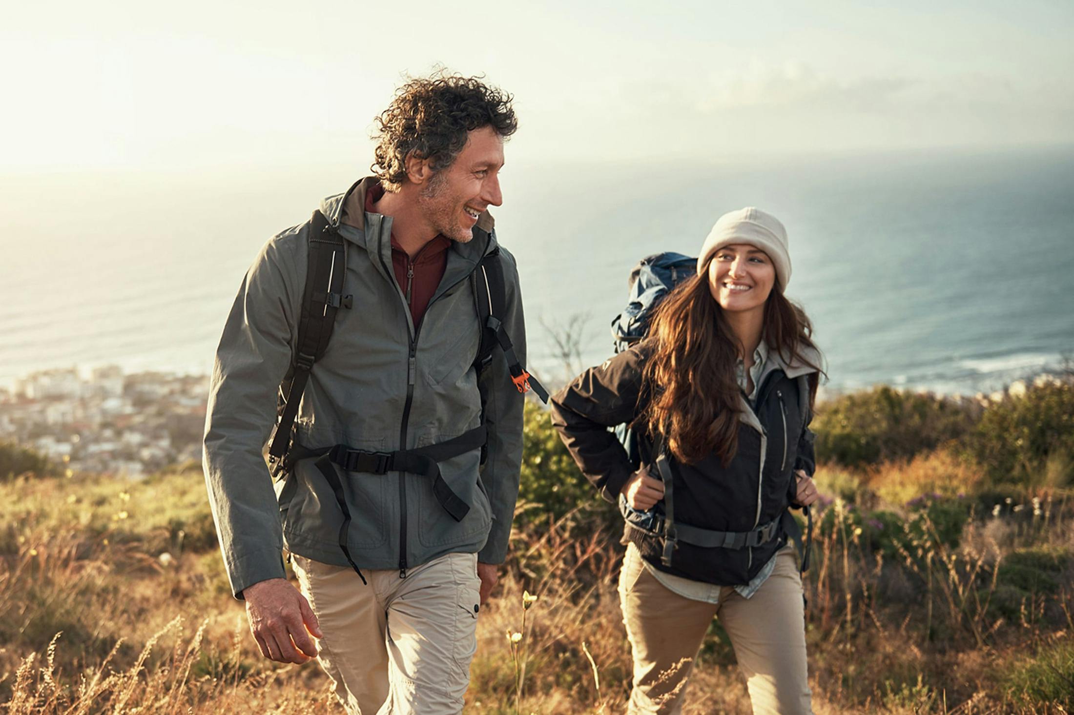 Happy couple hiking after HRT from Genesis Lifestyle Medicine.
