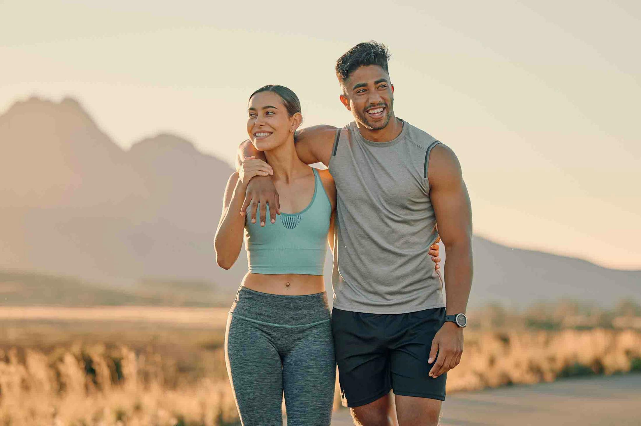 Happy couple walking outside after receiving CoolSculpting from Genesis Lifestyle Medicine.