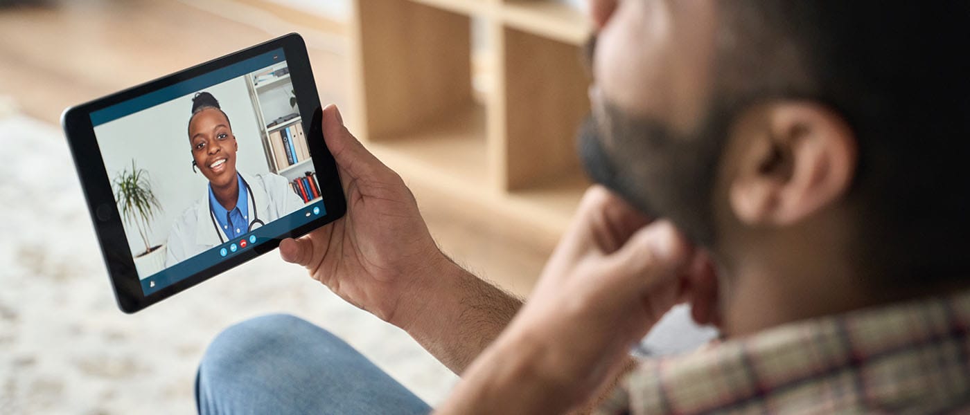 Man talking to a Genesis Lifestyle Medicine doctor on a telehealth call.