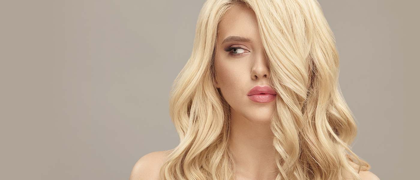 Patient showcases her full, healthy hair after personalized restoration treatments at Genesis Lifestyle Medicine.