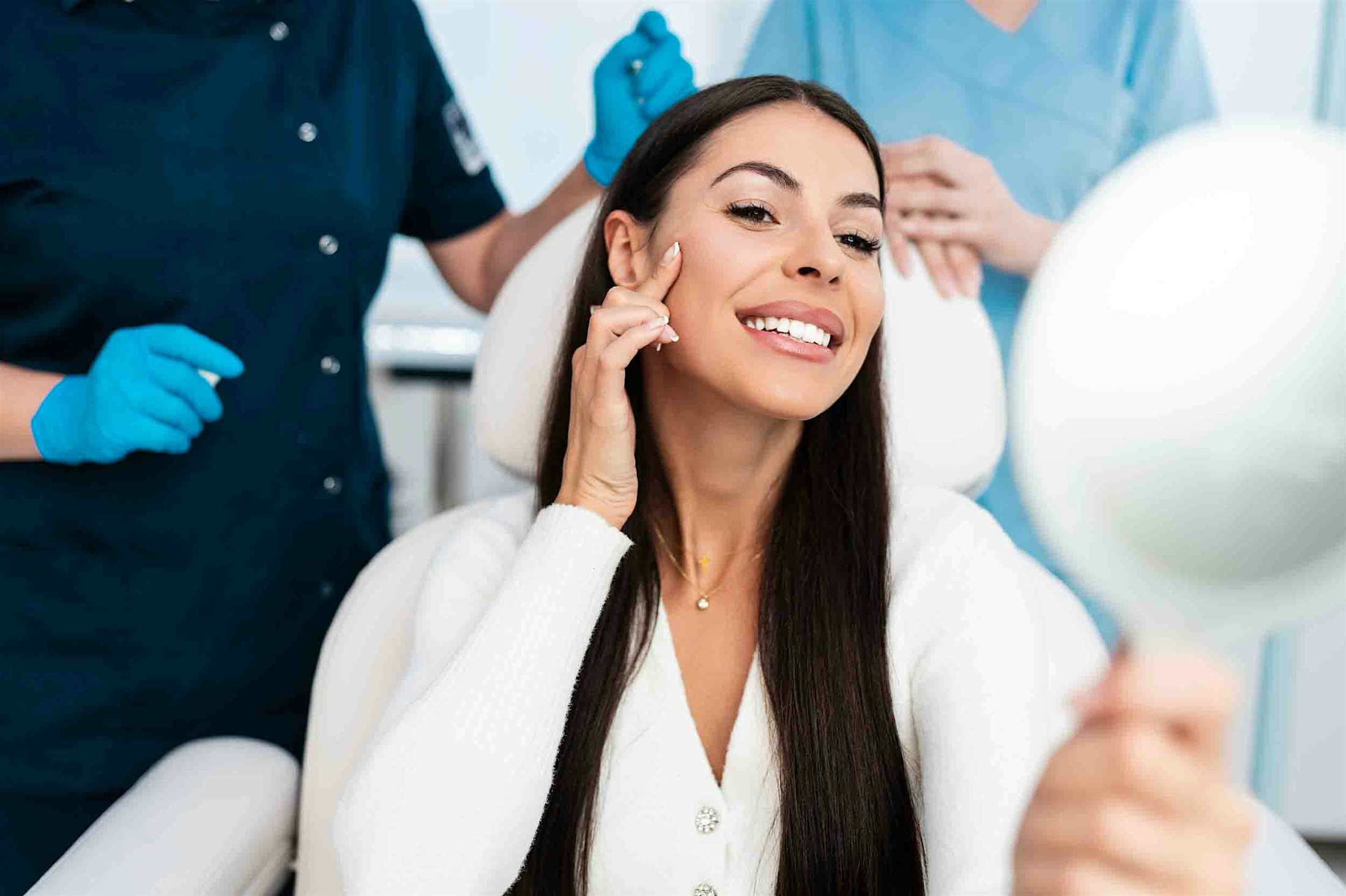 woman looking in mirror after receiving dermal fillers in Denver