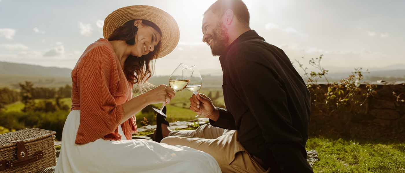 Happy couple having a picnic after GAINSWave therapy from Genesis Lifestyle Medicine.