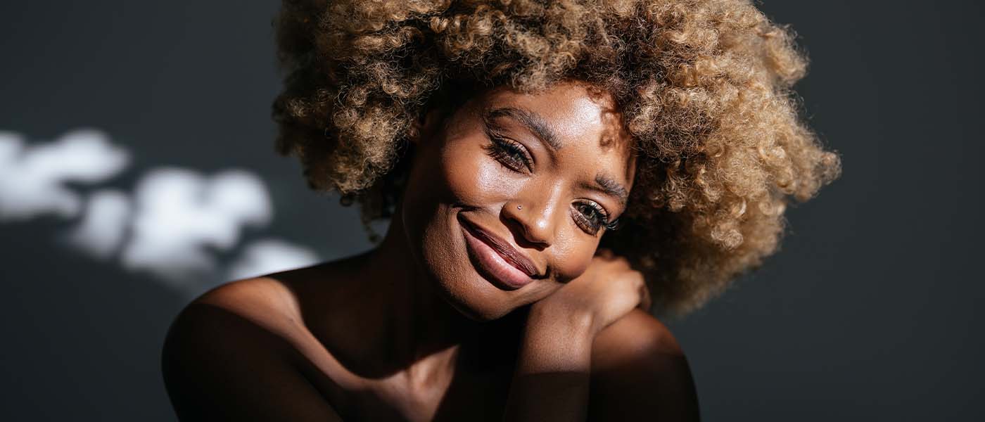 Woman with smoother skin following Genesis Lifestyle Medicine’s advanced tightening treatment.