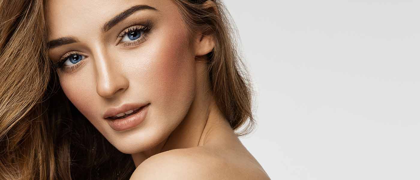 A woman’s toned, lifted complexion post skin tightening therapy at Genesis Lifestyle Medicine.