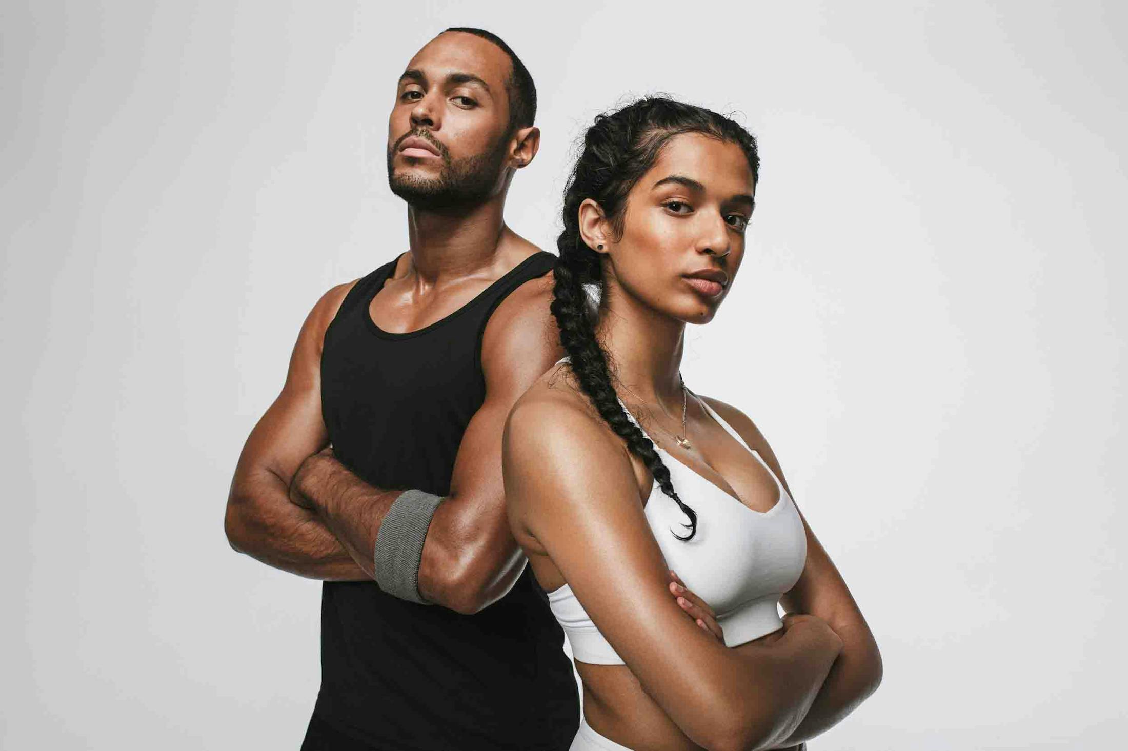 Fit couple in athletic wear feeling confident after CoolSculpting at Genesis Lifestyle Medicine.