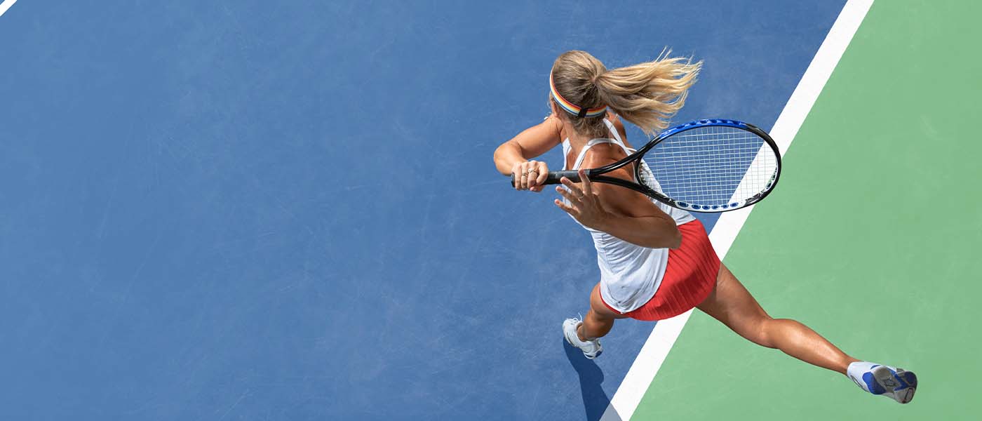 Tennis player mid-swing, reflecting improved core stability and power after Emsculpt NEO treatment at Genesis Lifestyle Medicine.