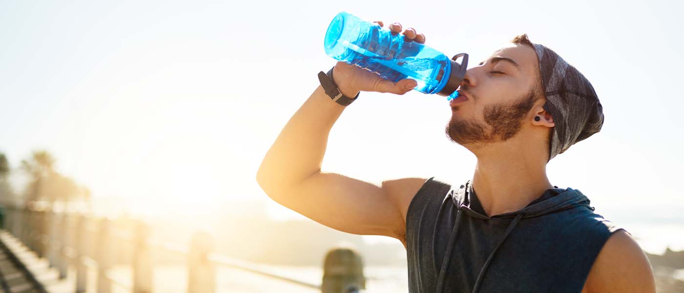 Man drinking water after taking Semaglutide from Genesis Lifestyle Medicine.