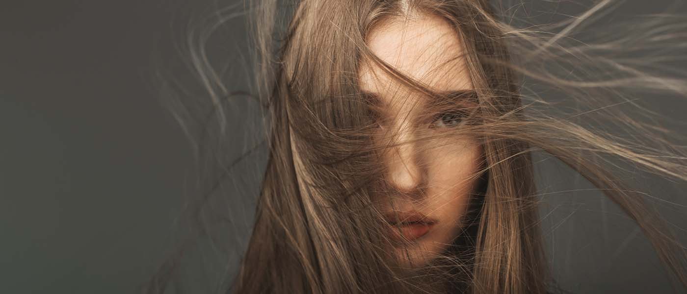 Woman with healthy, voluminous hair after PRP treatment at Genesis Lifestyle Medicine.