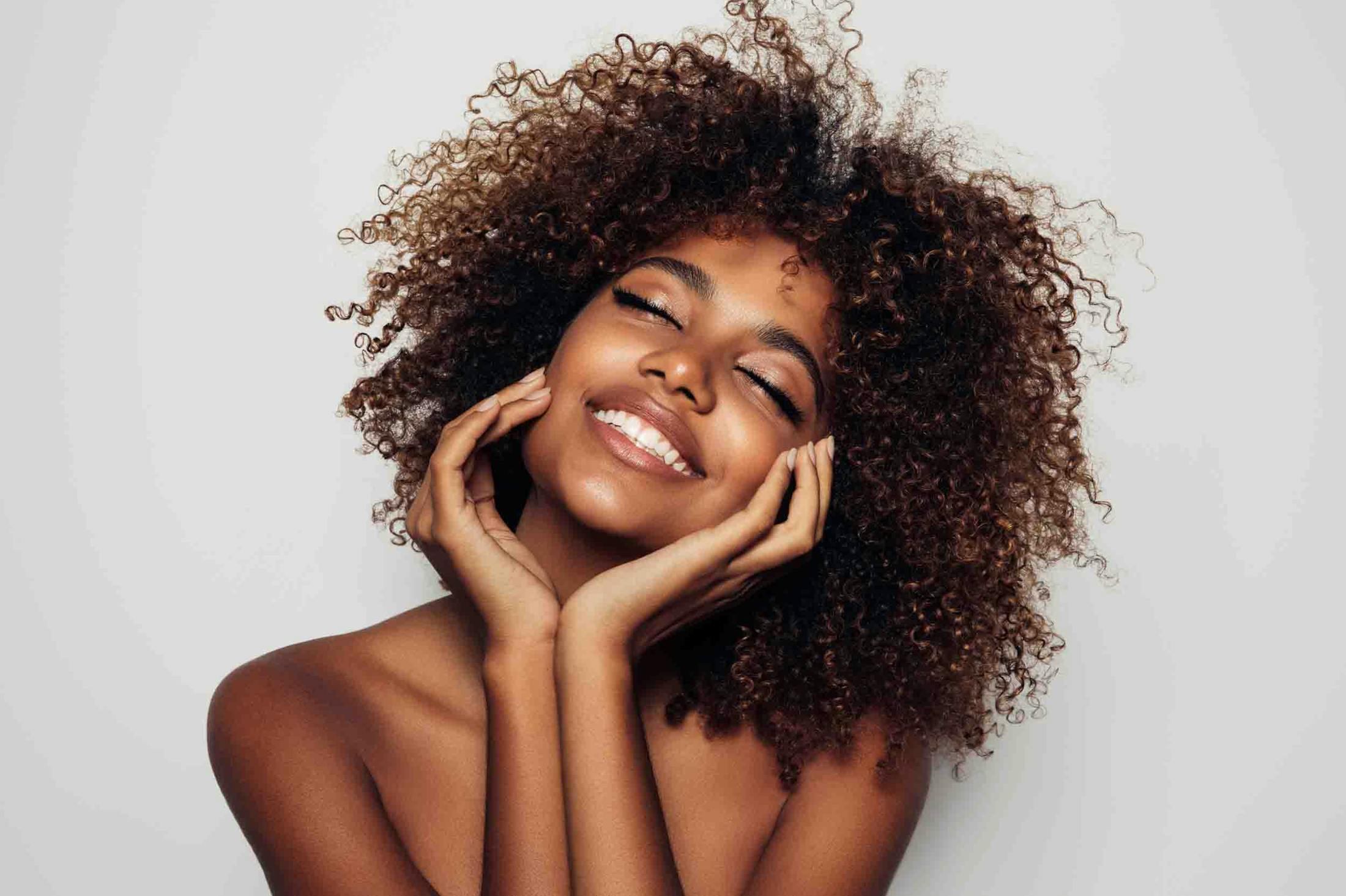 Woman showing smooth, glowing skin after Morpheus8 treatment at Genesis Lifestyle Medicine.