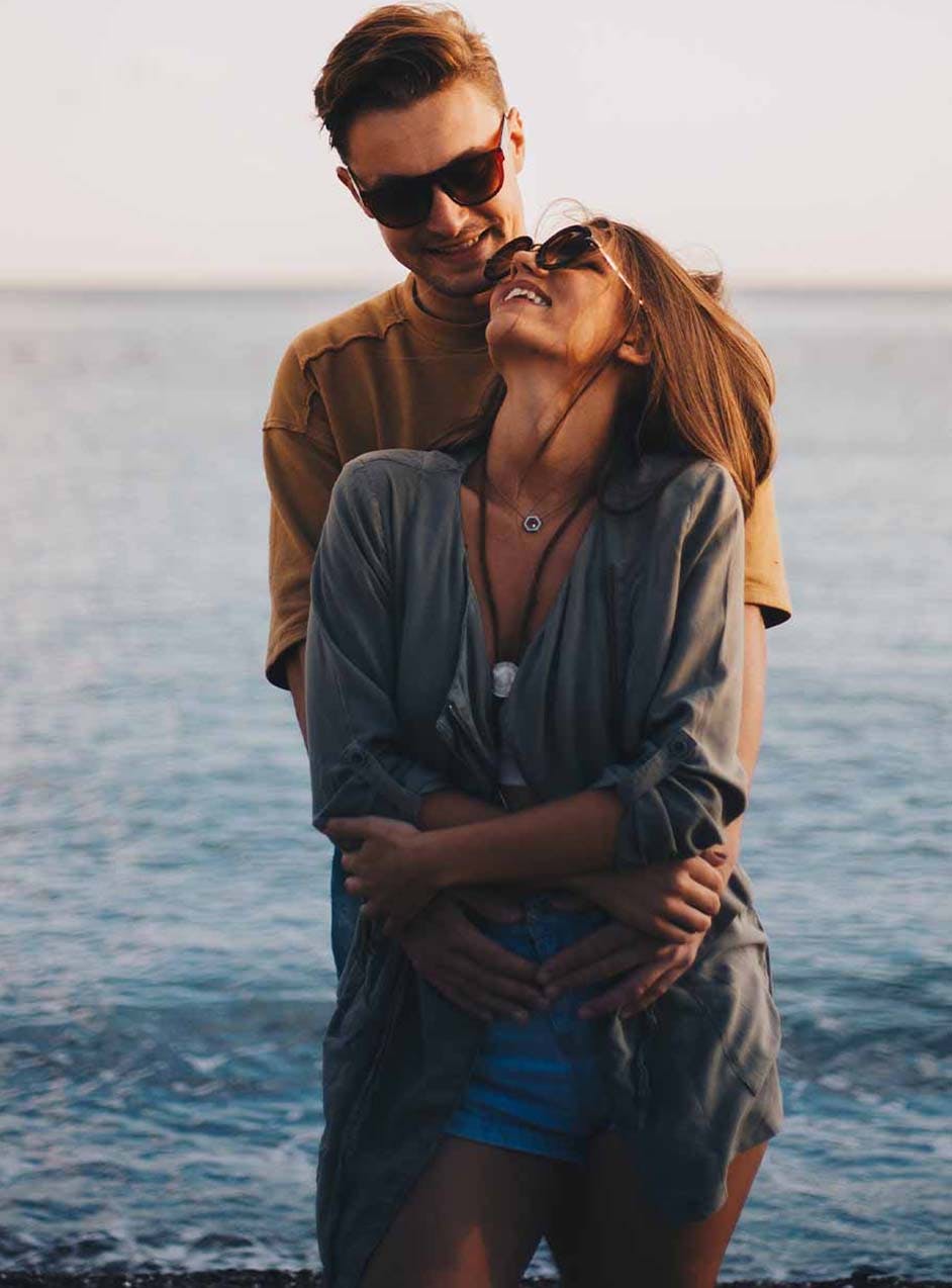 passionate couple at the beach after vaginal rejuvenation in Denver, CO