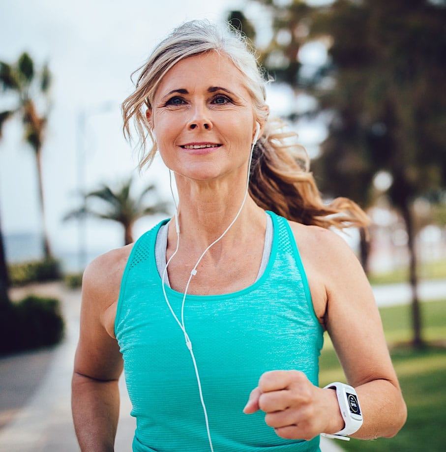confident older woman jogging after hormone therapy in Omaha, NE