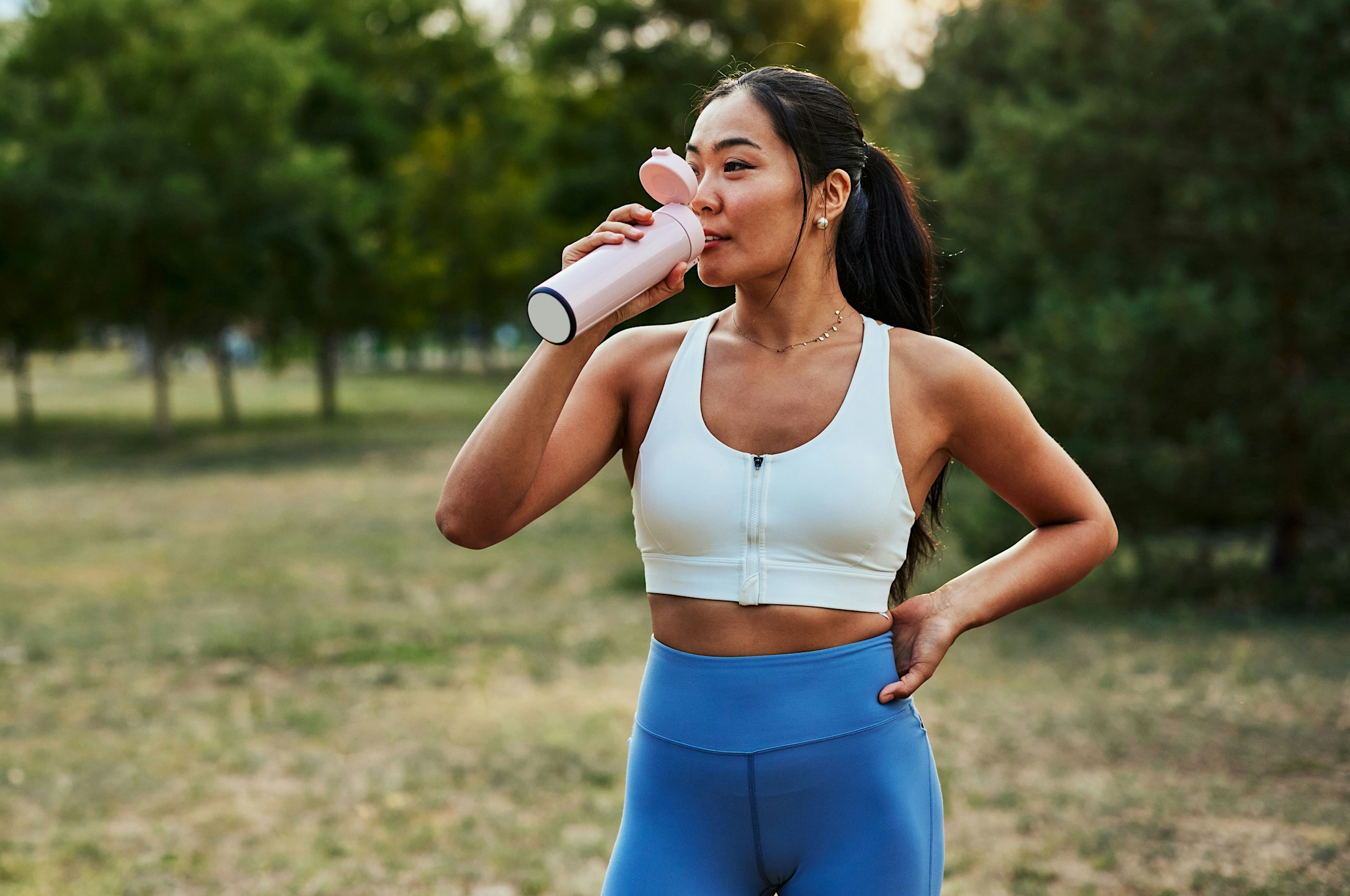 thin woman drinking water after GLP-1 medication in Frisco