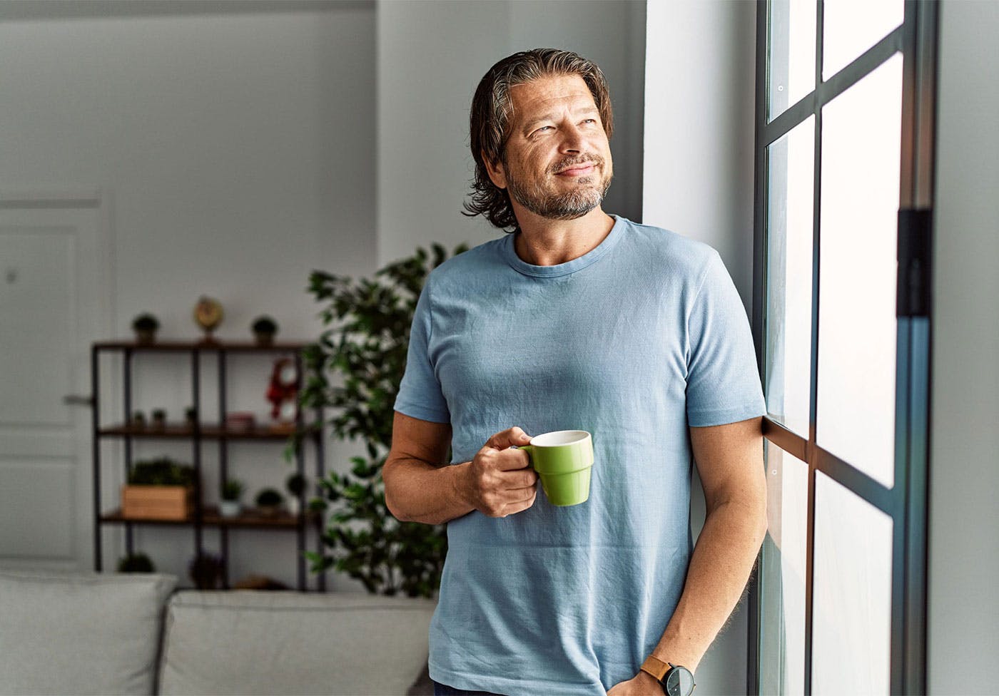 Man drinking coffee after taking Ozempic at Genesis Lifestyle Medicine.
