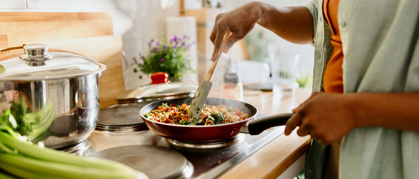 woman making a healthy meal after medical weight loss program from Genesis Lifestyle Medicine