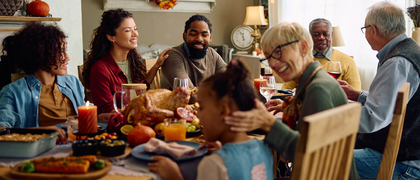 Happy family eating dinner after weight loss program from Genesis Lifestyle Medicine.