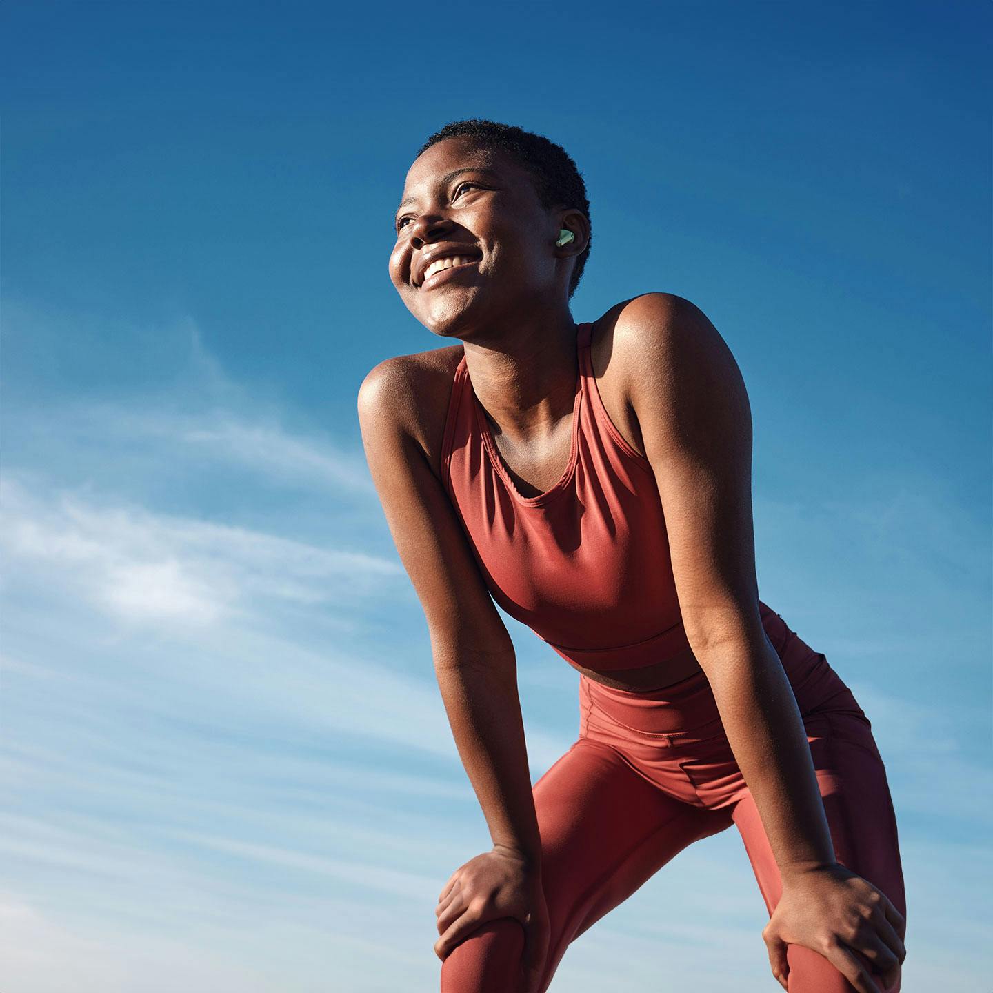 a woman smiling and leaning forward after getting GLP-1 in San Diego.