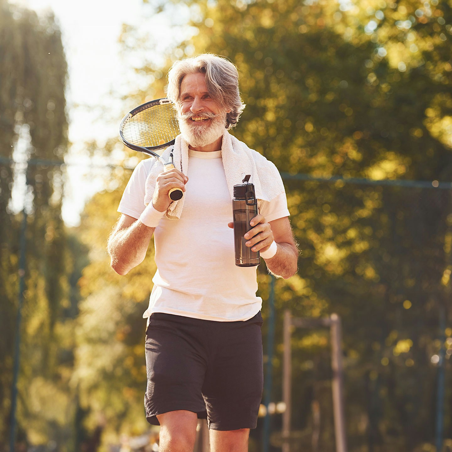 older man playing tennis after weight loss medication in Austin, TX