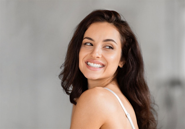 Confident woman smiling after starting hormone therapy at Genesis Lifestyle Medicine.