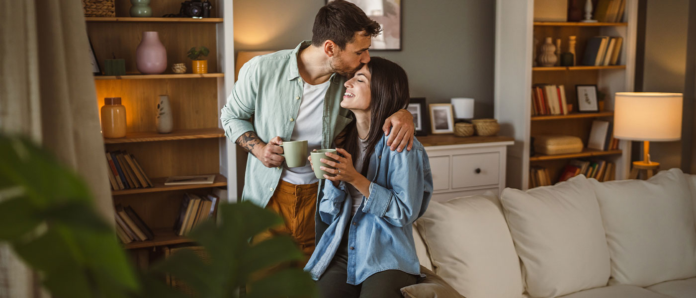Happy couple at home after GAINSWave therapy from Genesis Lifestyle Medicine.