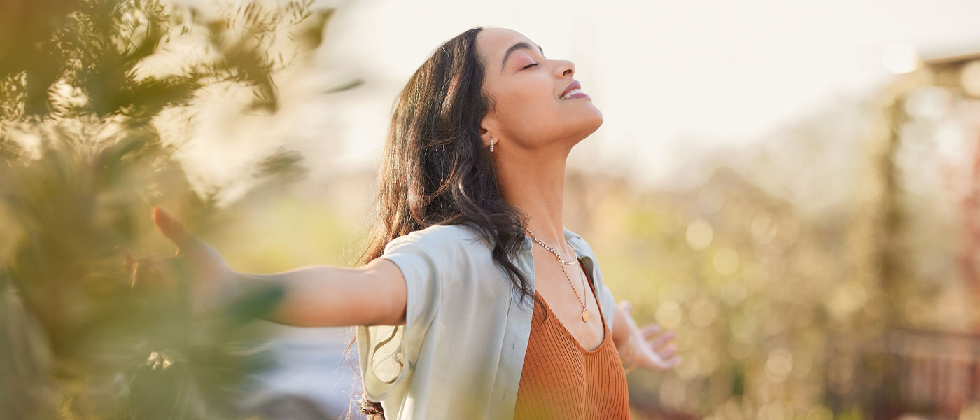 Happy woman outside after taking GLP-1 medication from Genesis Lifestyle Medicine.