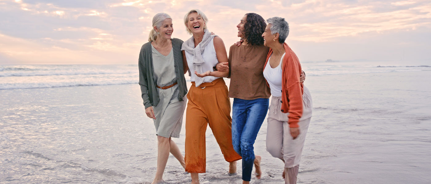 Happy women at the beach after hormone therapy from Genesis Lifestyle Medicine.