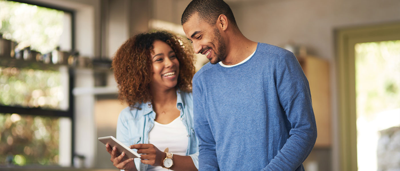Happy couple scheduling consultation at Genesis Lifestyle Medicine.