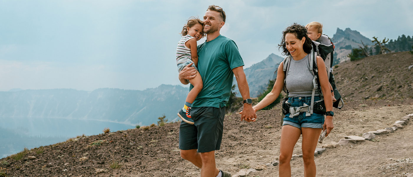Happy family hiking after medical weight loss program from Genesis Lifestyle Medicine.