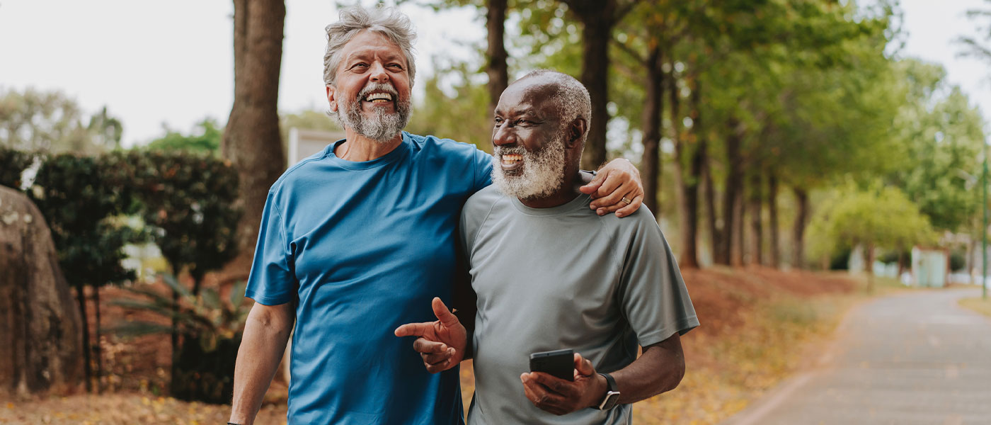 Laughing friends walking outside after weight loss program from Genesis Lifestyle Medicine.