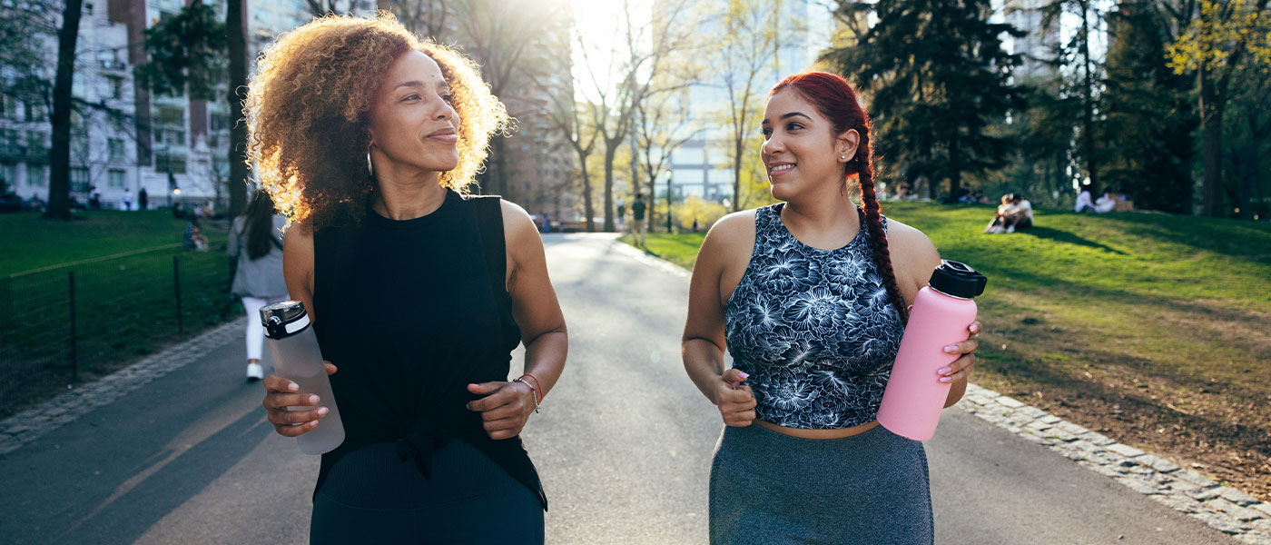 Two friends walking after taking GLP-1 medication from Genesis Lifestyle Medicine.