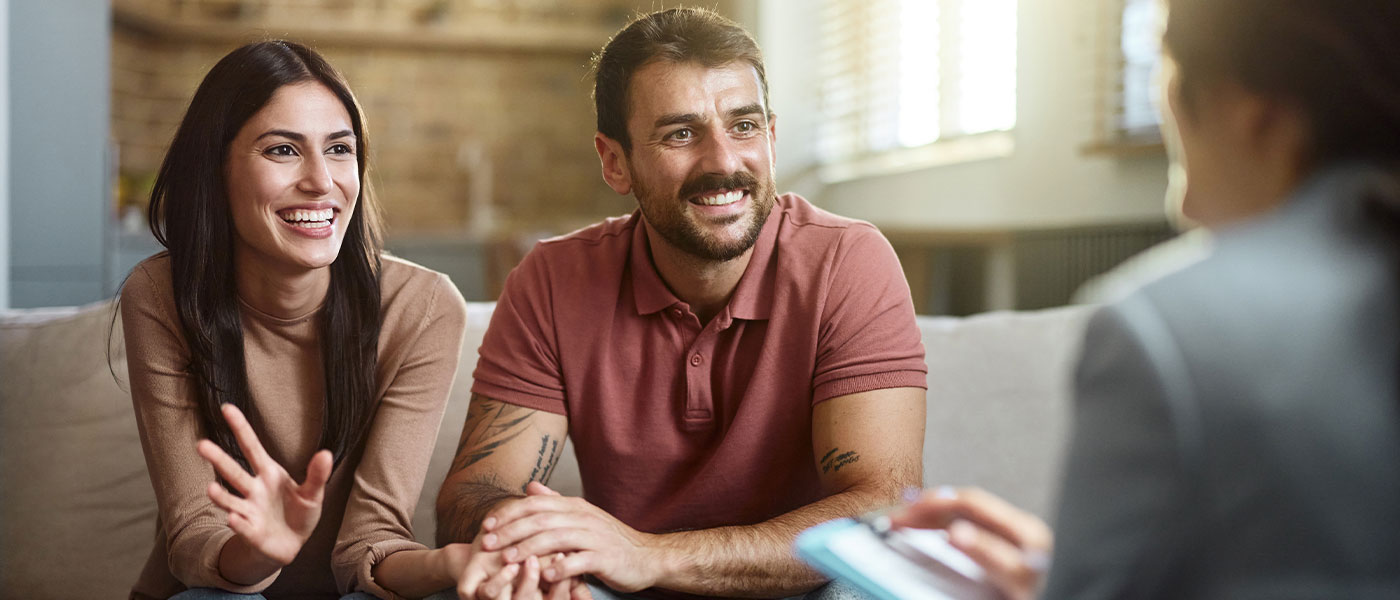 A happy couple smiling during their ED consultation at Genesis Lifestyle Medicine