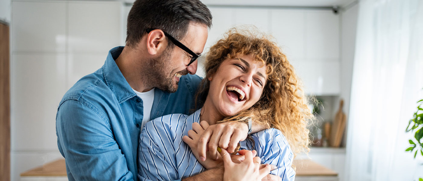 Happy couple laughing after GAINSWave therapy from Genesis Lifestyle Medicine.