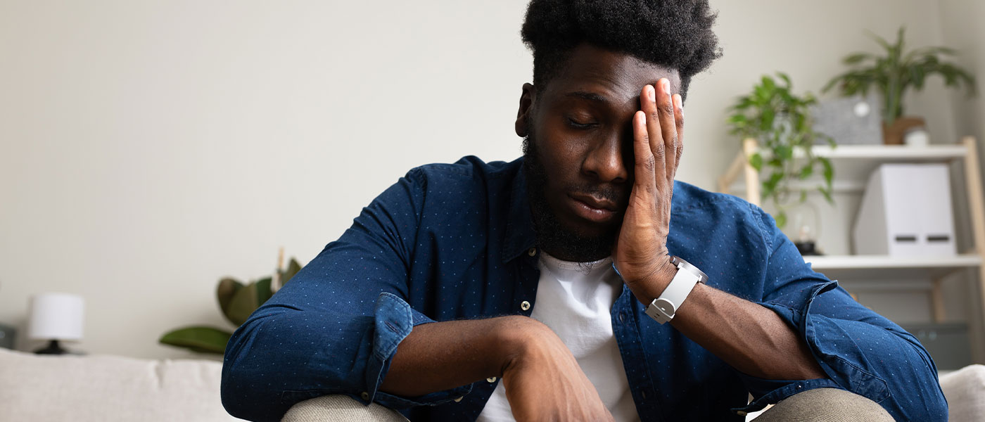 Frustrated man considering ED treatment from Genesis Lifestyle Medicine.