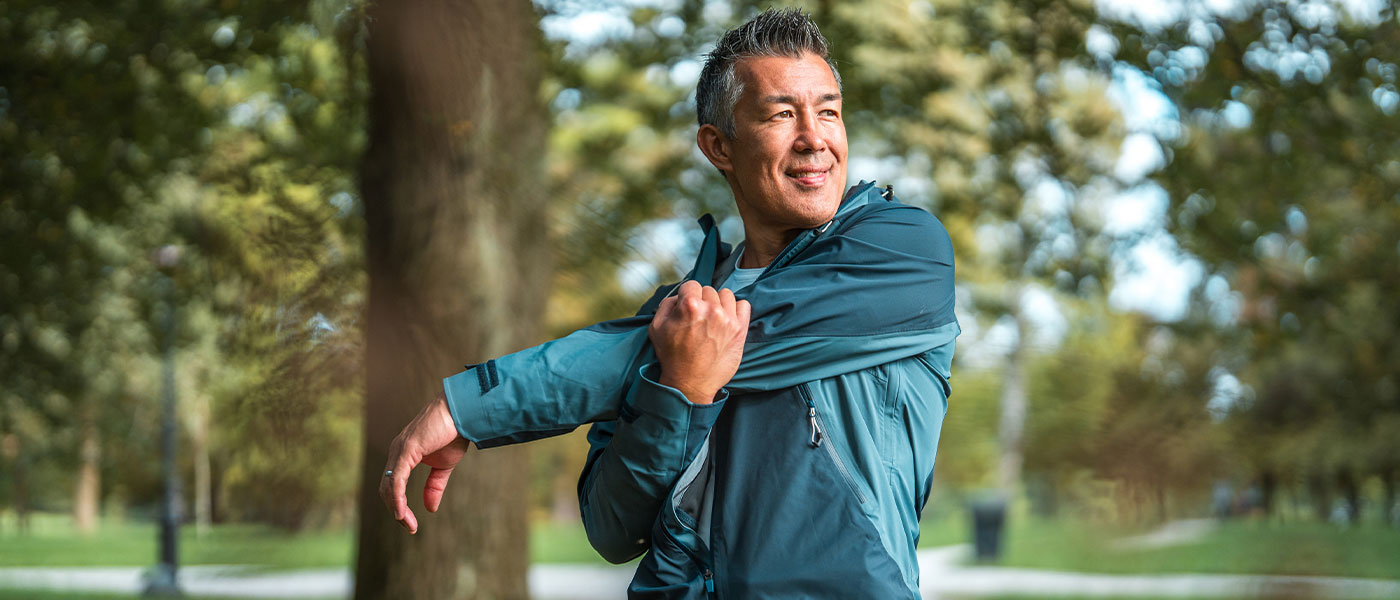 Happy man stretching outside after TRT from Genesis Lifestyle Medicine.