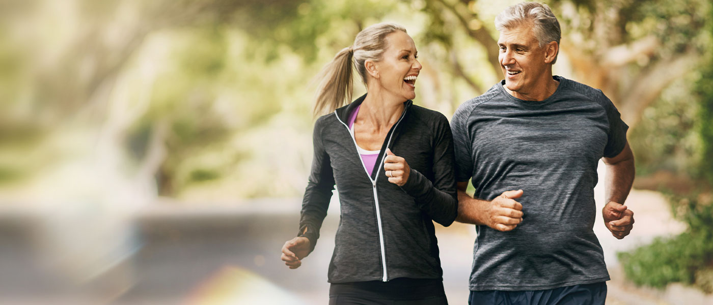Couple jogging outside after receiving hormone therapy from Genesis Lifestyle Medicine.