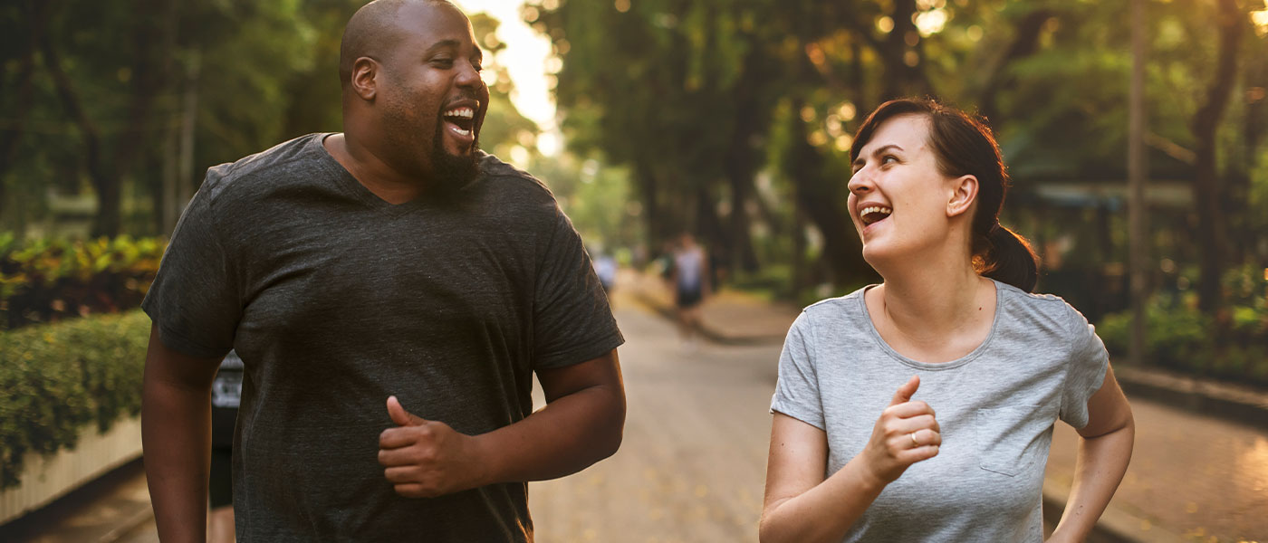 Happy friends walking outside after doing a weight loss program at Genesis Lifestyle Medicine.