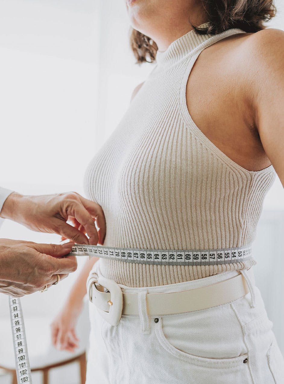 doctor measuring woman's waist after medical weight loss in Indianapolis