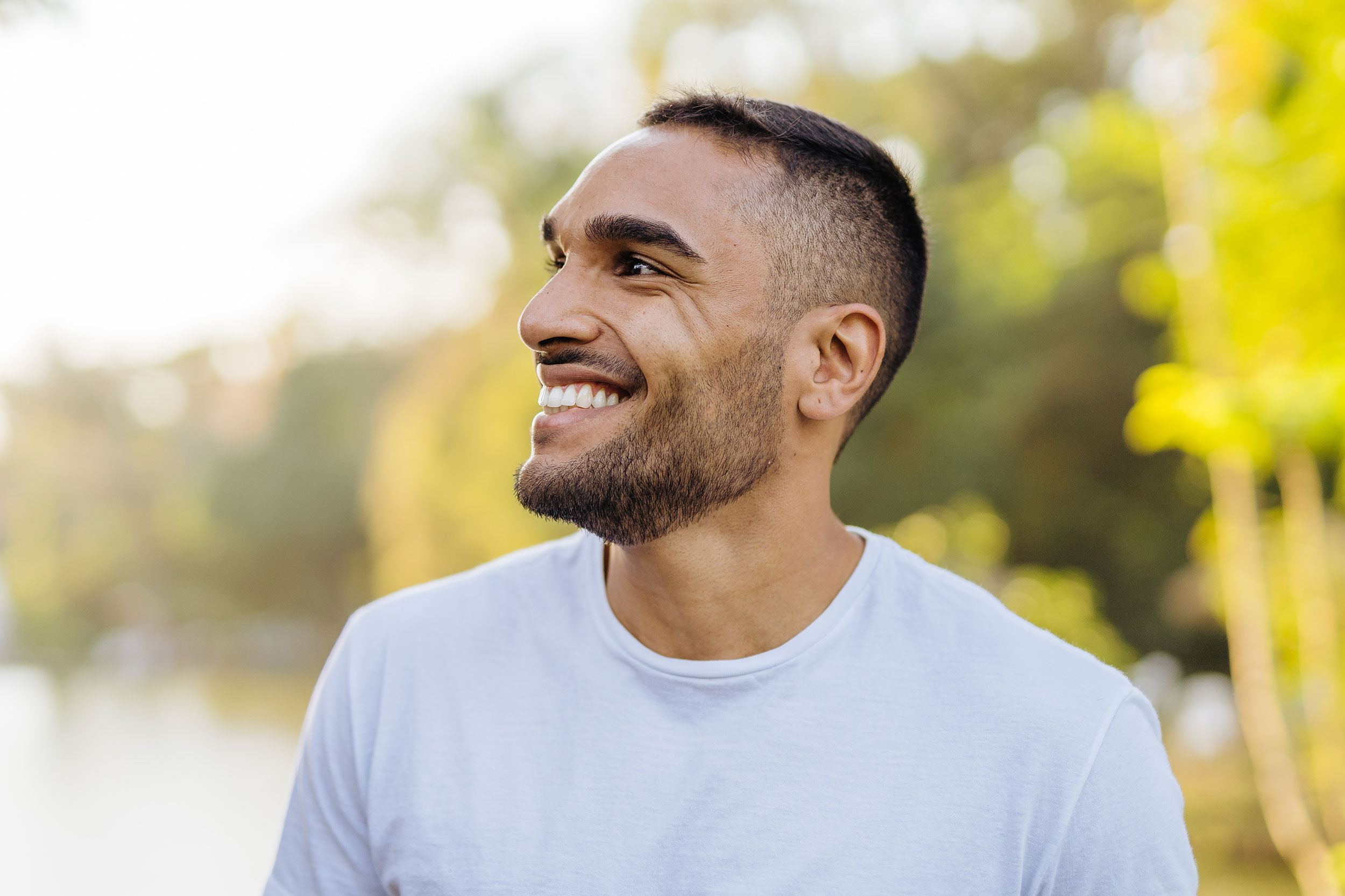 Confident man smiling after experiencing natural male enhancement with P-Long at Genesis Lifestyle Medicine.