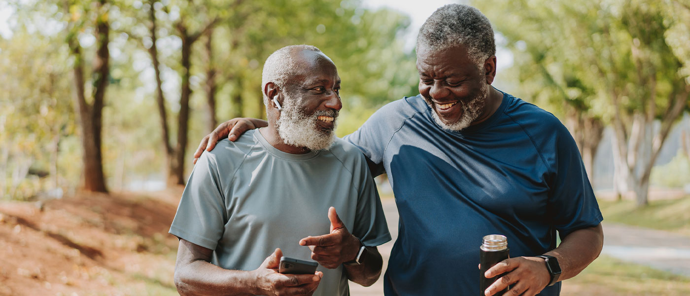 Two friends enjoying a relaxing walk, feeling youthful and refreshed after Sermorelin treatments at Genesis Lifestyle Medicine.