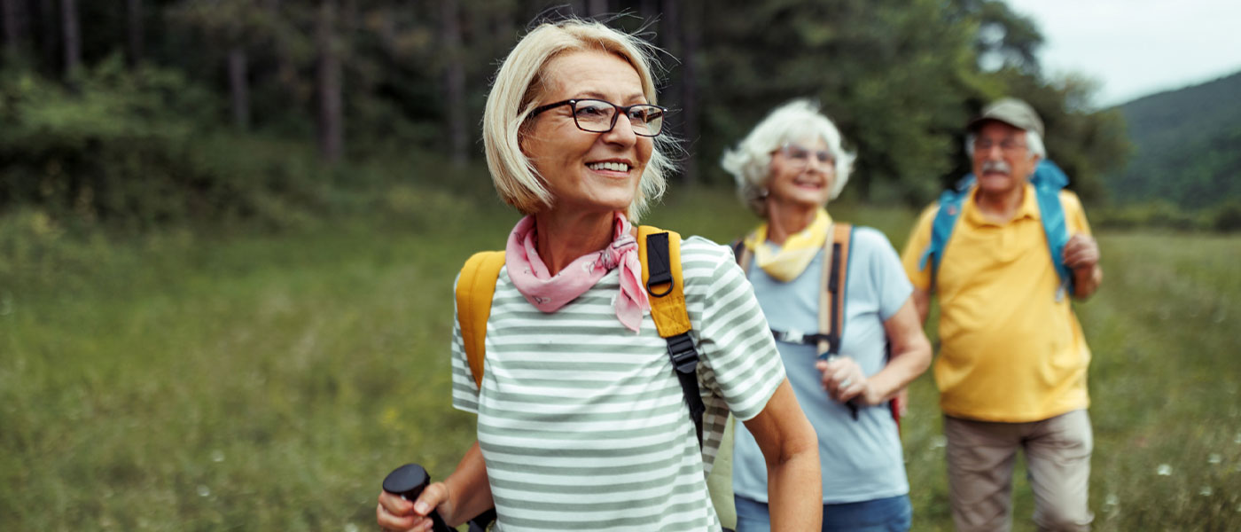 Group of friends hiking through scenic trail, energized and revitalized with Sermorelin therapy from Genesis Lifestyle Medicine.