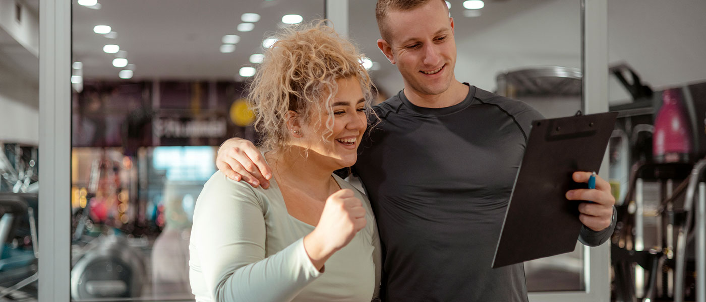 Active couple working out at the gym, boosting energy and performance with Sermorelin from Genesis Lifestyle Medicine.