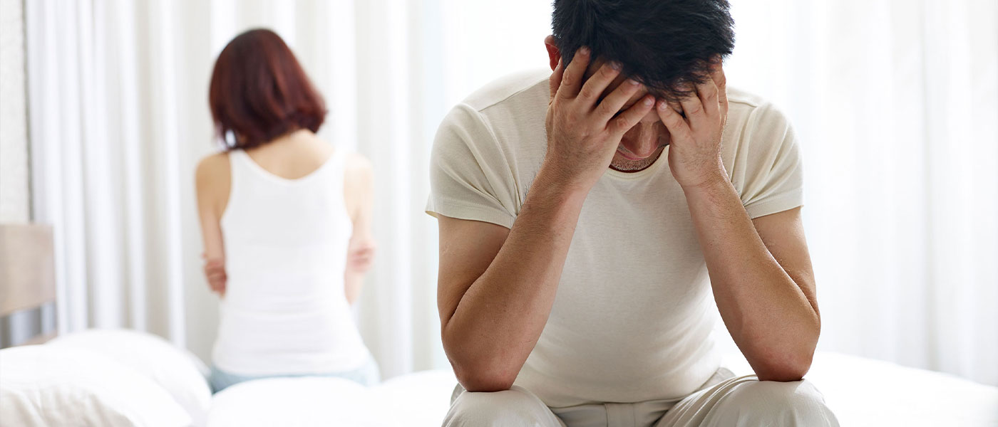 Concerned couple sitting together before learning about GAINSWave therapy options at Genesis Lifestyle Medicine.