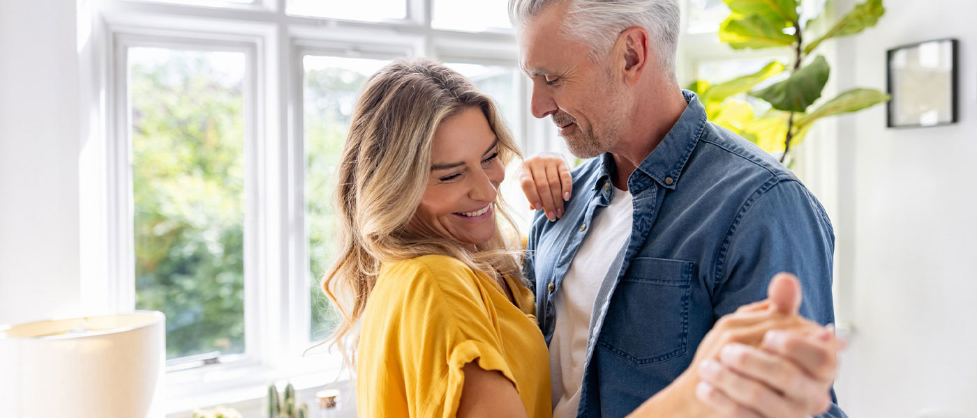 Lively couple dancing together, celebrating improved wellness with Sermorelin therapy at Genesis Lifestyle Medicine.