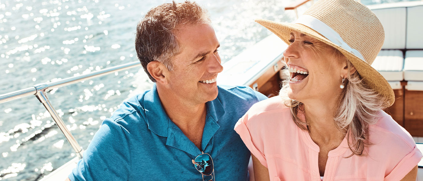 Smiling couple on a boat, enjoying a revitalized relationship with support from P-Long at Genesis Lifestyle Medicine.