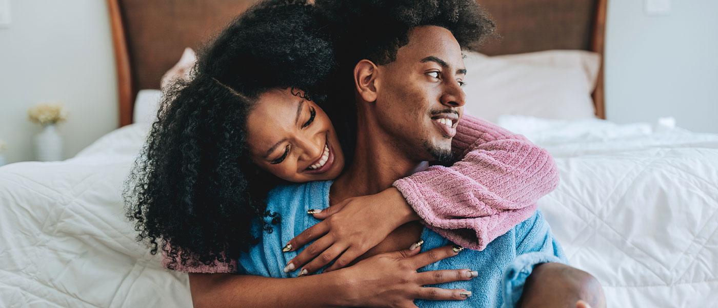 Laughing couple sharing a joyful moment, strengthened by intimacy benefits of P-Long therapy.