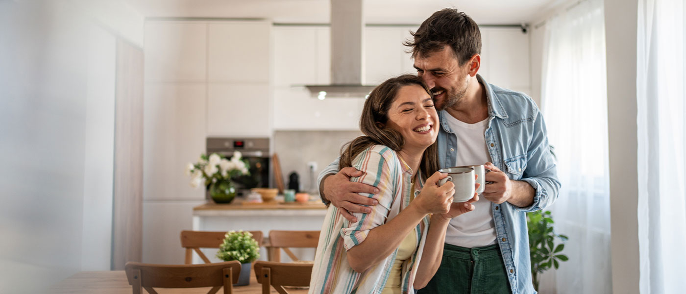 Laughing couple sharing a joyful moment, strengthened by intimacy benefits of P-Long therapy.