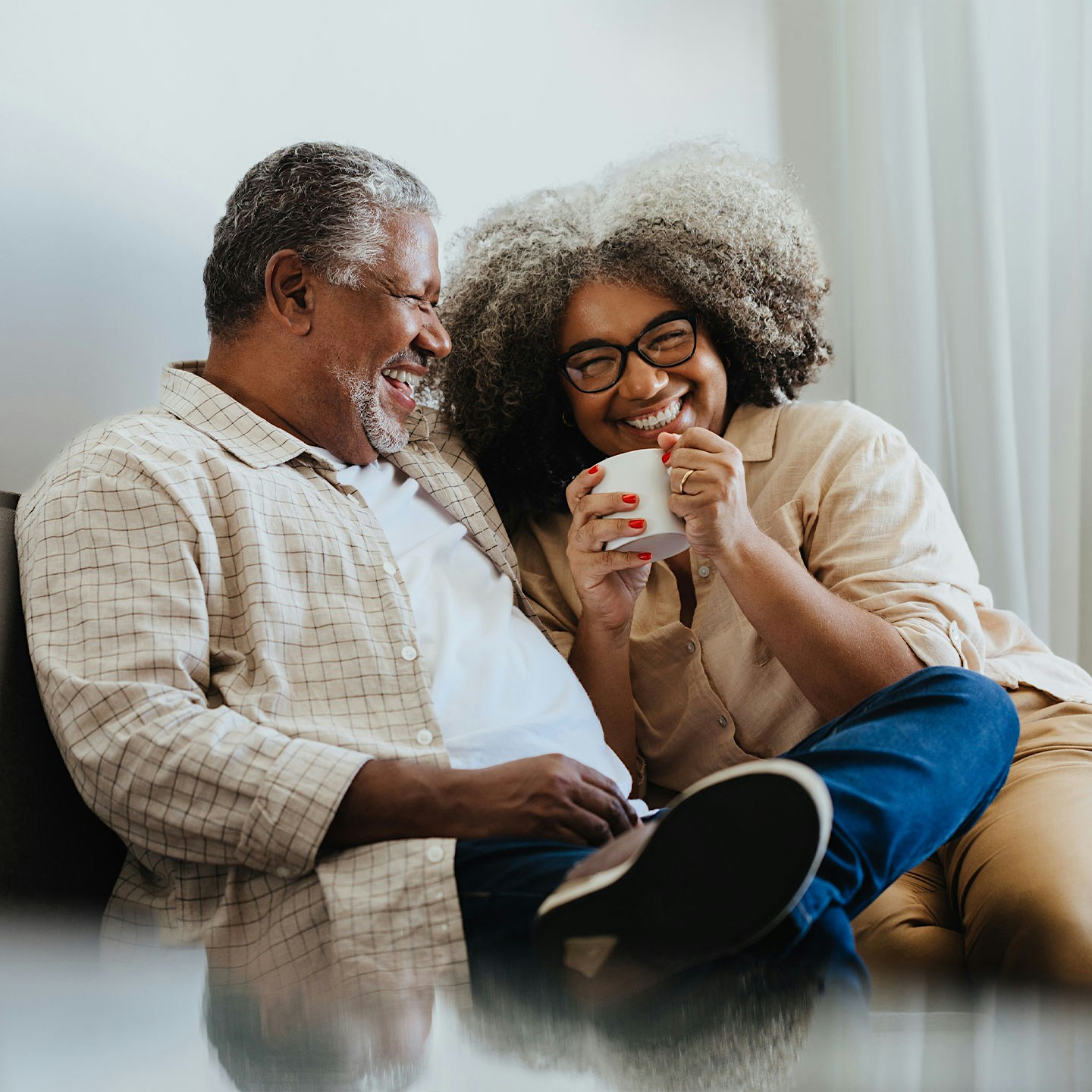 laughing older couple on the couch after Methylene Blue treatments in Las Vegas