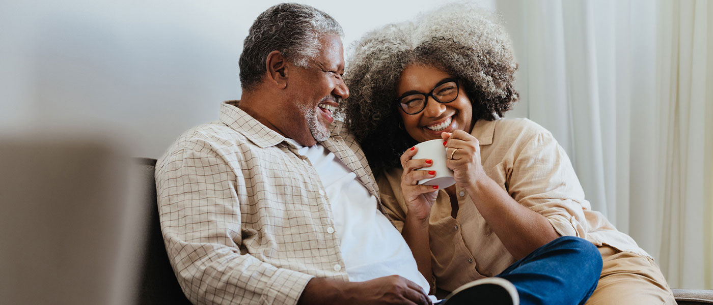 Happy couple relaxing at home, symbolizing the confidence and connection restored through GAINSWave therapy at Genesis Lifestyle Medicine.