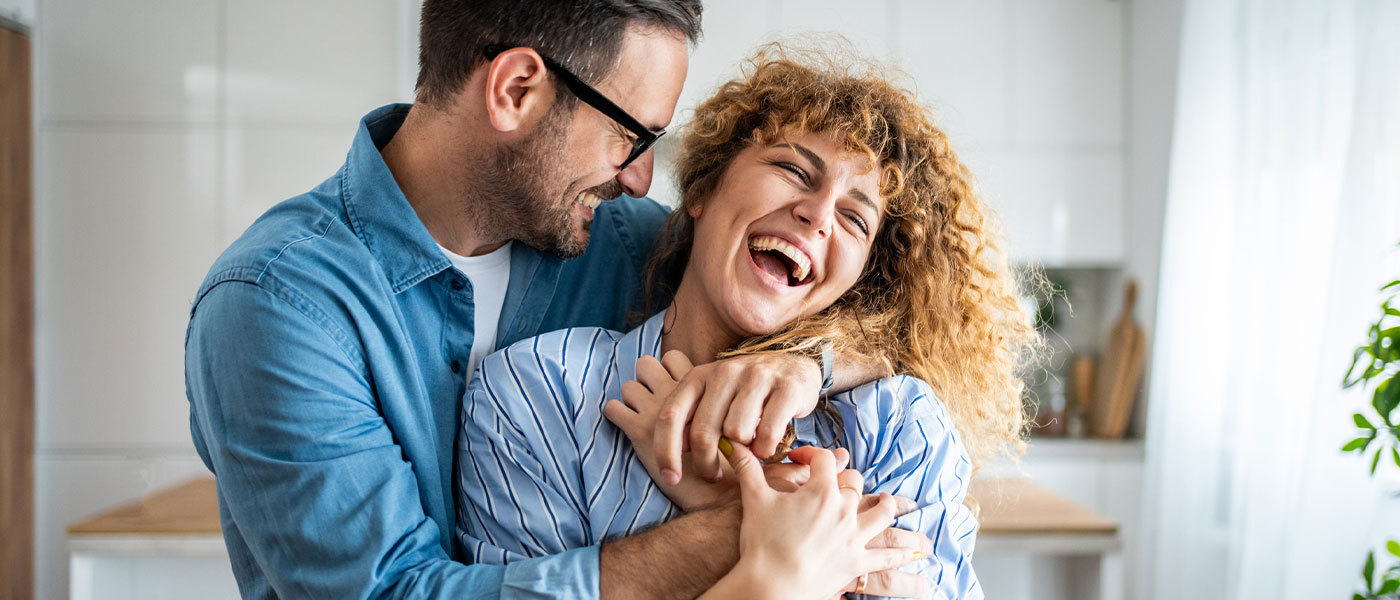 Happy couple laughing together, showcasing the emotional benefits of GAINSWave at Genesis Lifestyle Medicine
